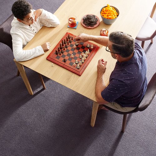 Father and son playing chess in a room with gray carpet floor The Carpet Shop - Inspired Floors for Less in Benton Harbor, MI